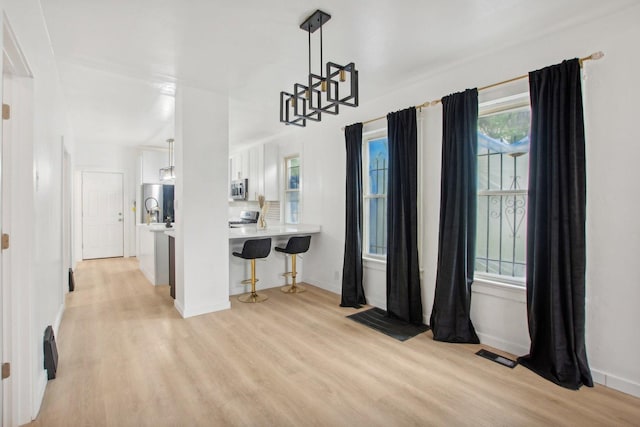 dining area with light hardwood / wood-style floors