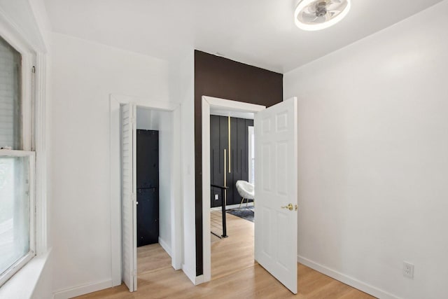 bedroom with baseboards and light wood-type flooring