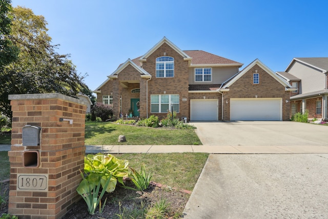 view of front facade with a garage and a front lawn