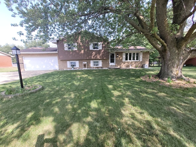 tri-level home featuring a garage and a front yard