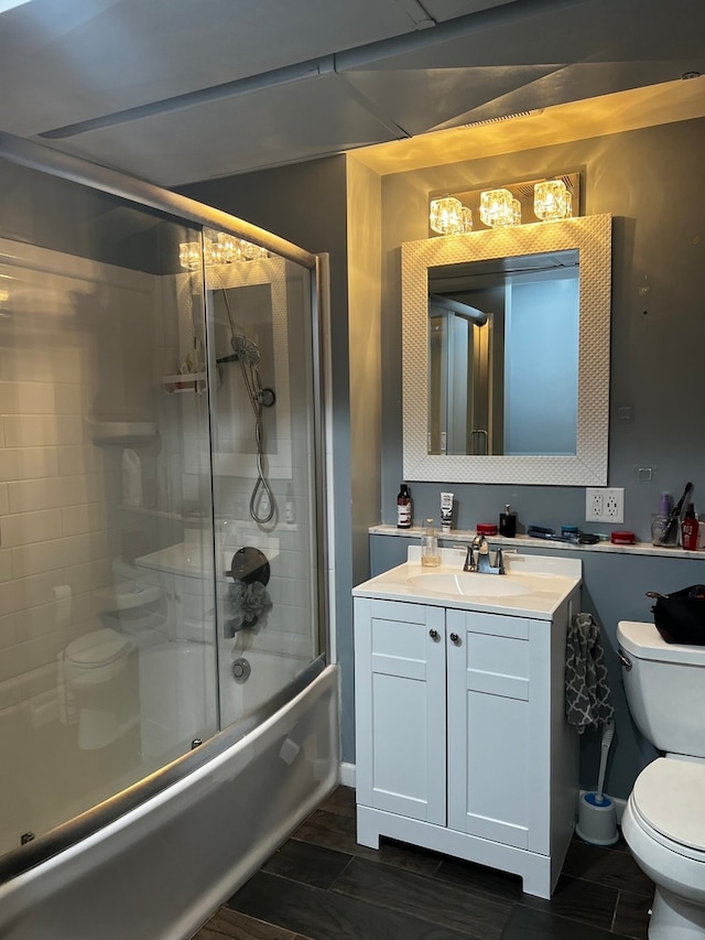 full bathroom with shower / bath combination with glass door, toilet, and vanity