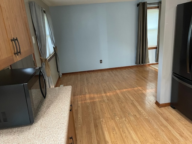 unfurnished living room with light hardwood / wood-style floors