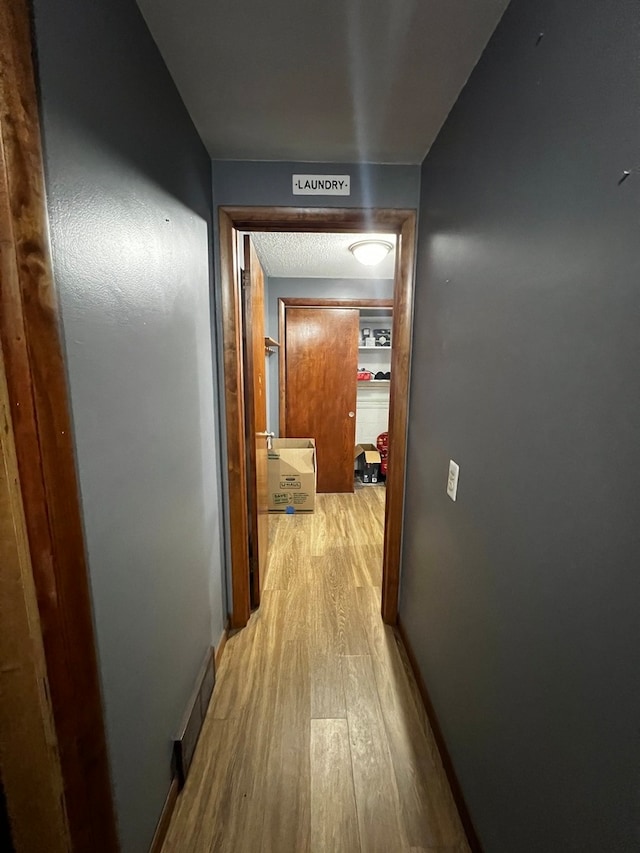 hall with light hardwood / wood-style floors