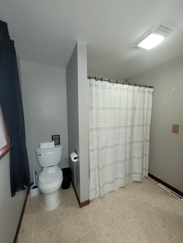 bathroom featuring tile patterned flooring and toilet