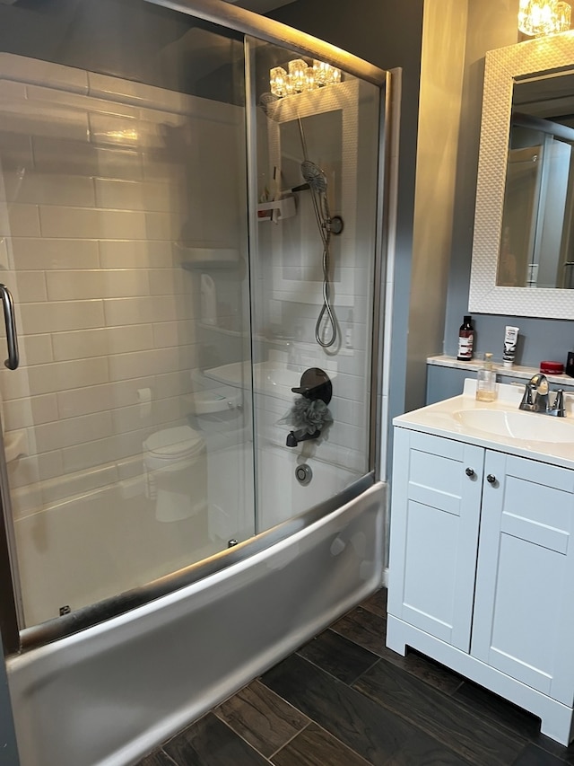 bathroom with vanity and bath / shower combo with glass door