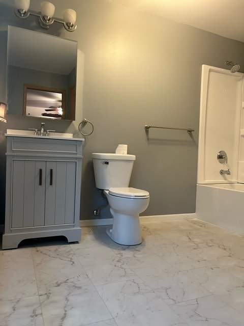 full bathroom with bathing tub / shower combination, vanity, and toilet