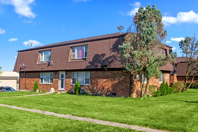 view of front of house featuring a front lawn, brick siding, and a shingled roof