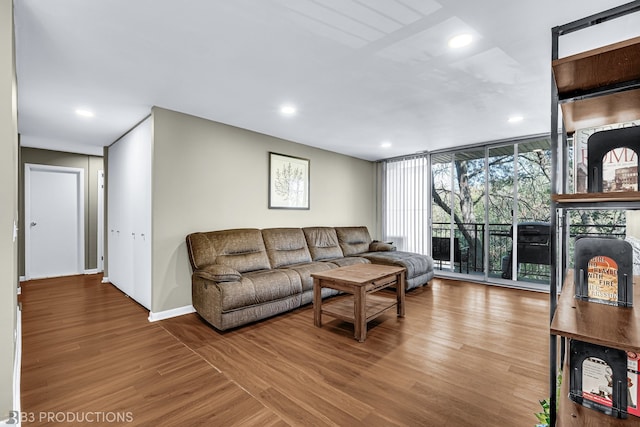 living room with floor to ceiling windows and hardwood / wood-style floors