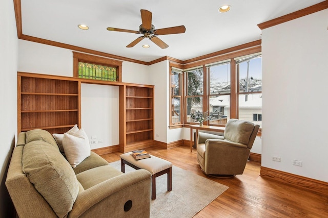 living room with ceiling fan, light hardwood / wood-style flooring, and ornamental molding