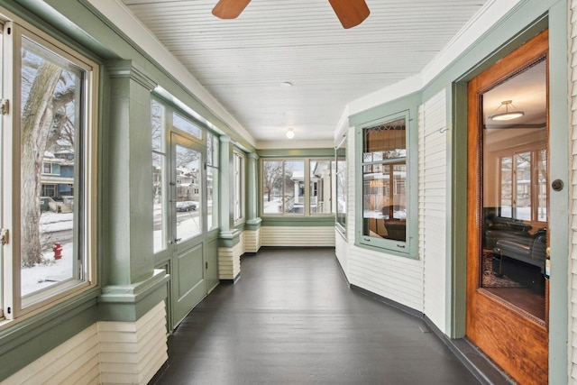 sunroom / solarium with a wealth of natural light and ceiling fan