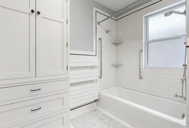 bathroom featuring tile patterned floors and tiled shower / bath