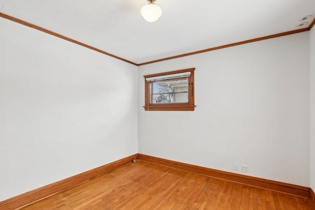 spare room featuring hardwood / wood-style floors and ornamental molding