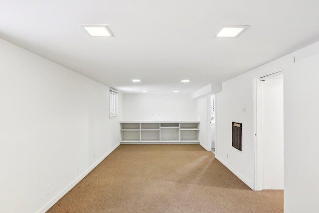 basement featuring light colored carpet