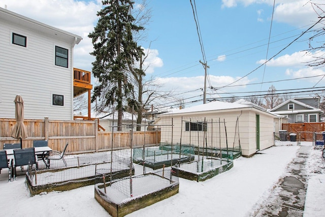 yard covered in snow featuring a shed