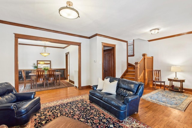 living room featuring crown molding and hardwood / wood-style floors