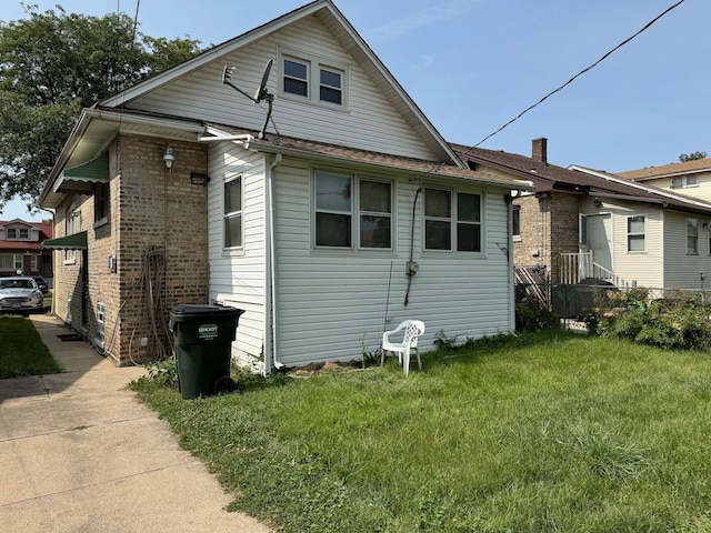 rear view of house with a yard