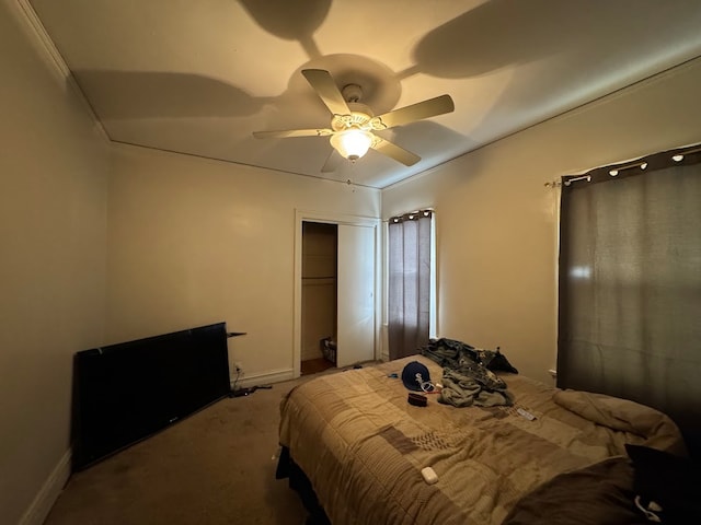 carpeted bedroom featuring crown molding, ceiling fan, and a closet