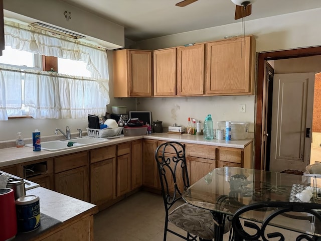 kitchen featuring light tile patterned floors, sink, and ceiling fan