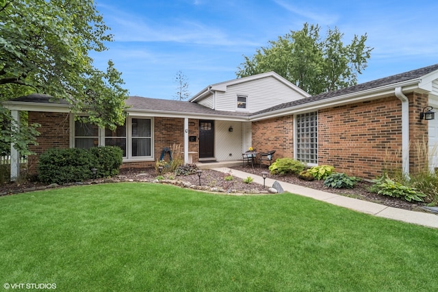 view of front of property with a patio area and a front lawn