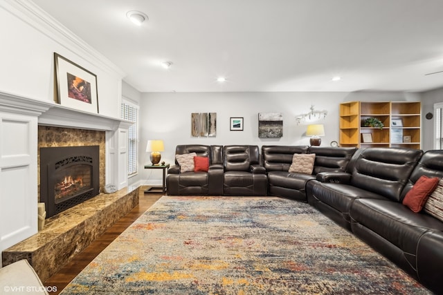 living room with a high end fireplace and dark hardwood / wood-style flooring