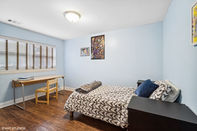 bedroom with dark hardwood / wood-style flooring