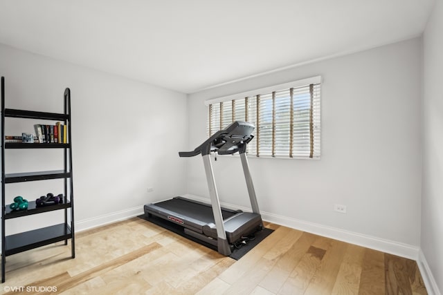 workout area with light hardwood / wood-style flooring