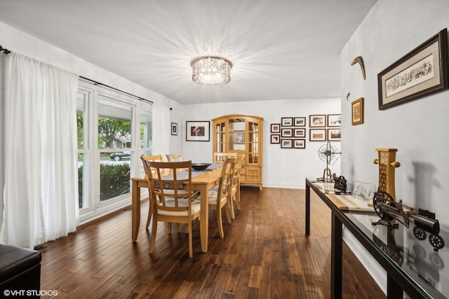 dining area featuring dark hardwood / wood-style floors and a notable chandelier