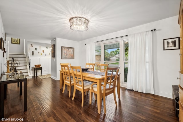 dining area with a notable chandelier and dark hardwood / wood-style floors