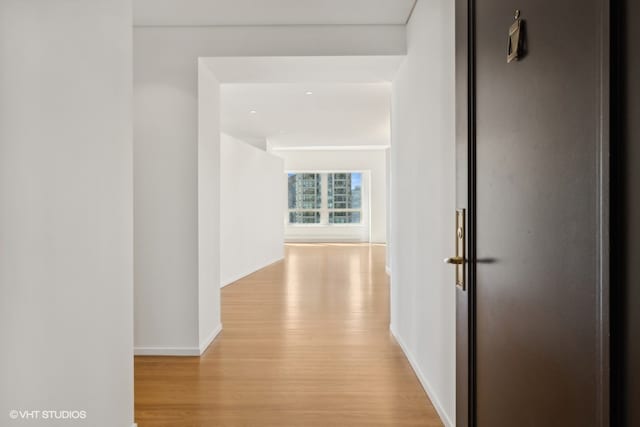 hallway with light hardwood / wood-style floors