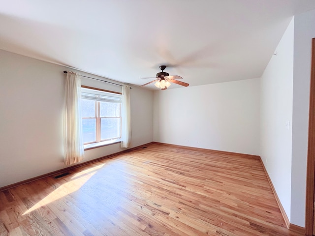 spare room with light hardwood / wood-style flooring and ceiling fan