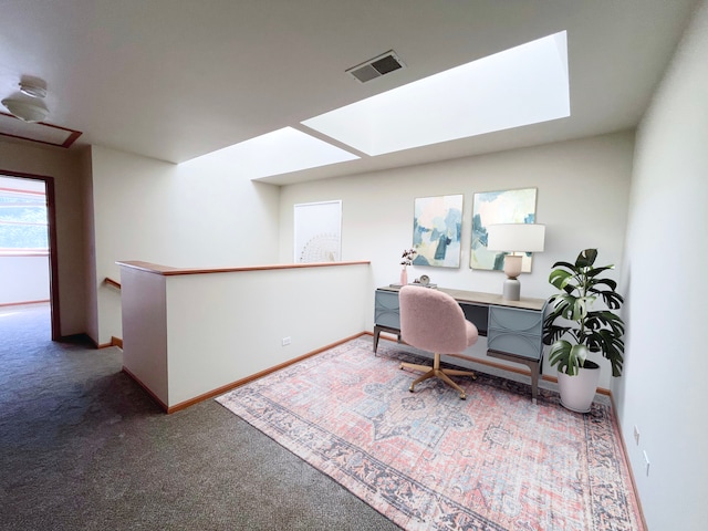 home office with a skylight and carpet