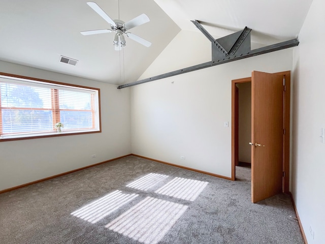 carpeted empty room featuring ceiling fan and vaulted ceiling