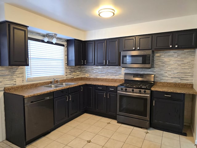 kitchen with decorative backsplash, appliances with stainless steel finishes, sink, and light tile patterned flooring