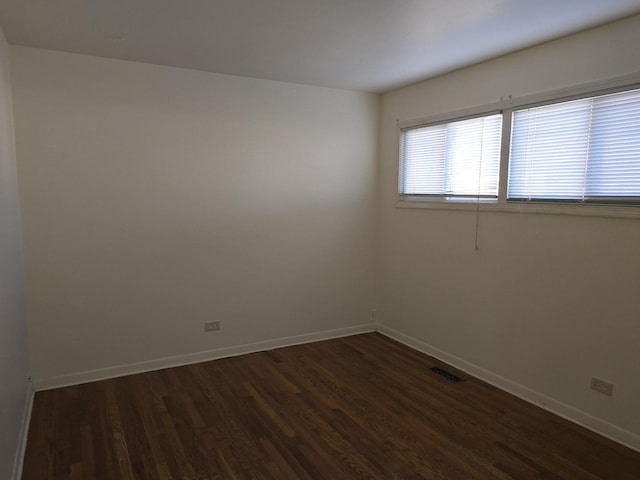 spare room with dark hardwood / wood-style floors