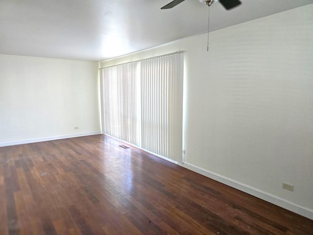 empty room featuring ceiling fan and dark hardwood / wood-style floors