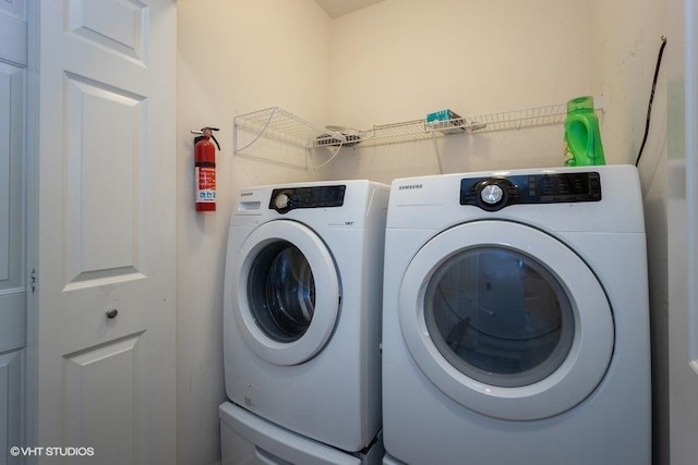 clothes washing area featuring washer and clothes dryer