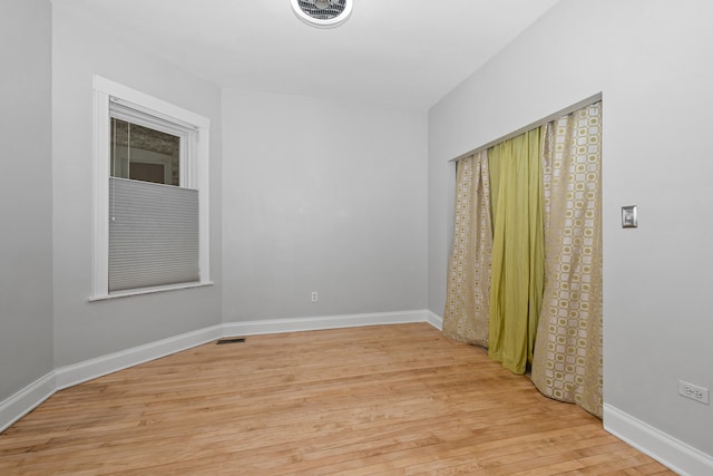 unfurnished room with light wood-type flooring