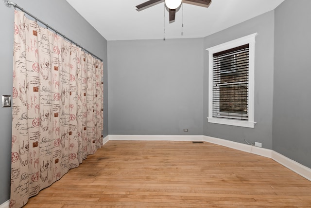 spare room with light hardwood / wood-style flooring and ceiling fan