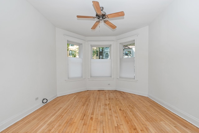 empty room featuring ceiling fan and light wood-type flooring