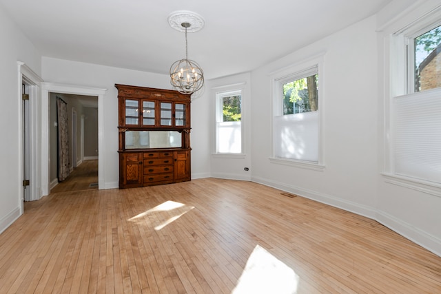 unfurnished room with light hardwood / wood-style flooring and plenty of natural light