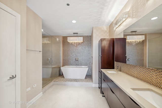 bathroom featuring vanity, tile patterned floors, and shower with separate bathtub