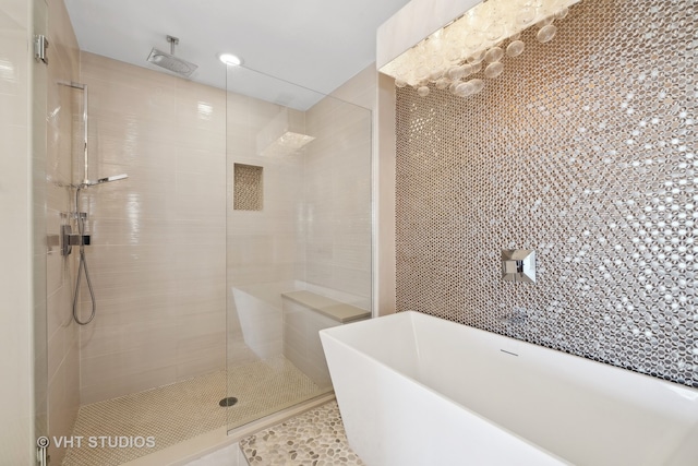 bathroom with shower with separate bathtub