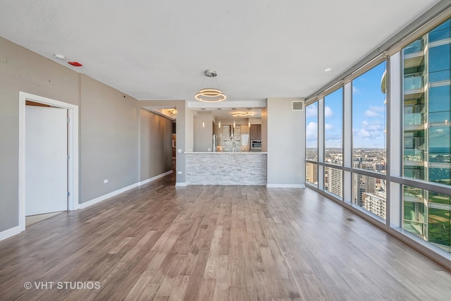 unfurnished living room with wood-type flooring and sink