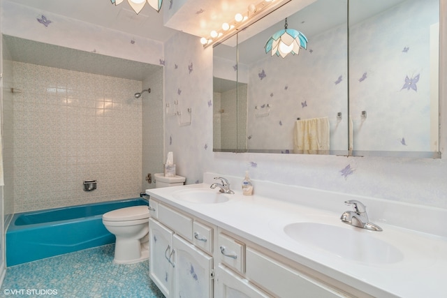 full bathroom featuring tiled shower / bath, vanity, and toilet