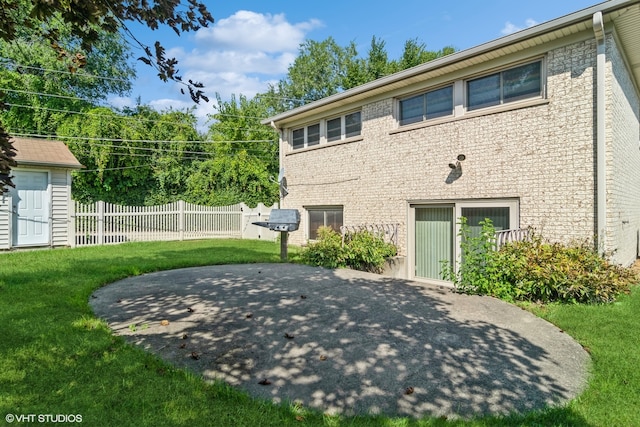 back of house featuring a patio area and a lawn