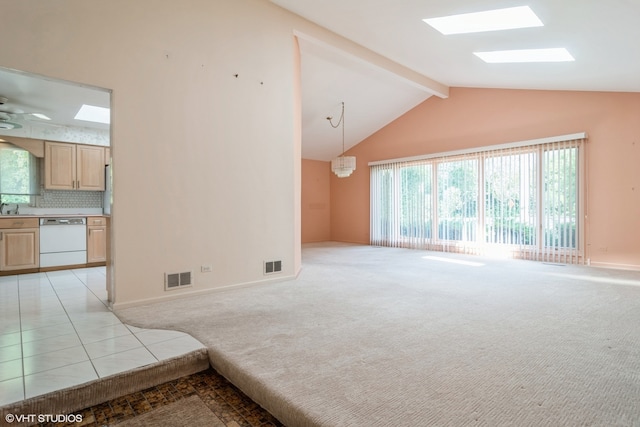 carpeted living room featuring beamed ceiling, a skylight, high vaulted ceiling, and ceiling fan