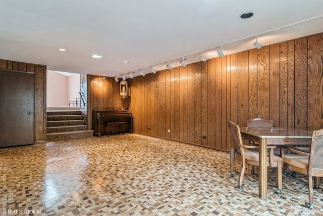 unfurnished dining area featuring wood walls