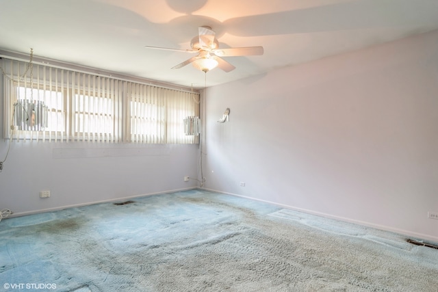 spare room with carpet and ceiling fan