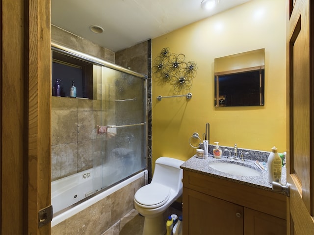 full bathroom featuring vanity, toilet, and bath / shower combo with glass door