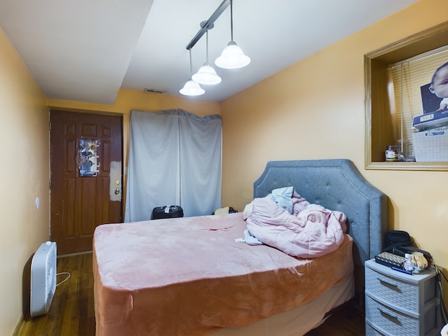 bedroom featuring dark wood-type flooring